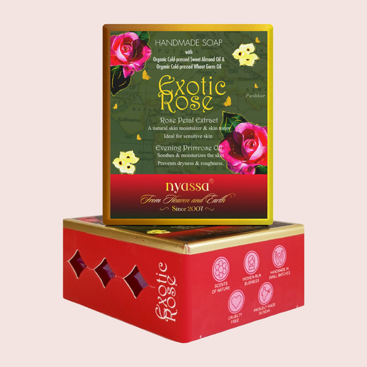 A boxed handmade soap product displayed on top of its red and gold retail box. The front label reads 'Exotic Rose' and 'Nyassa From Flowers and Earth Since 2013,' with pink rose illustrations and green background artwork.