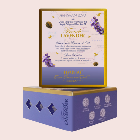A boxed handmade soap product shown on a plain light beige background. The top box displays the front label with lavender illustrations and product text, while a matching blue and gold soap box sits underneath as the base.