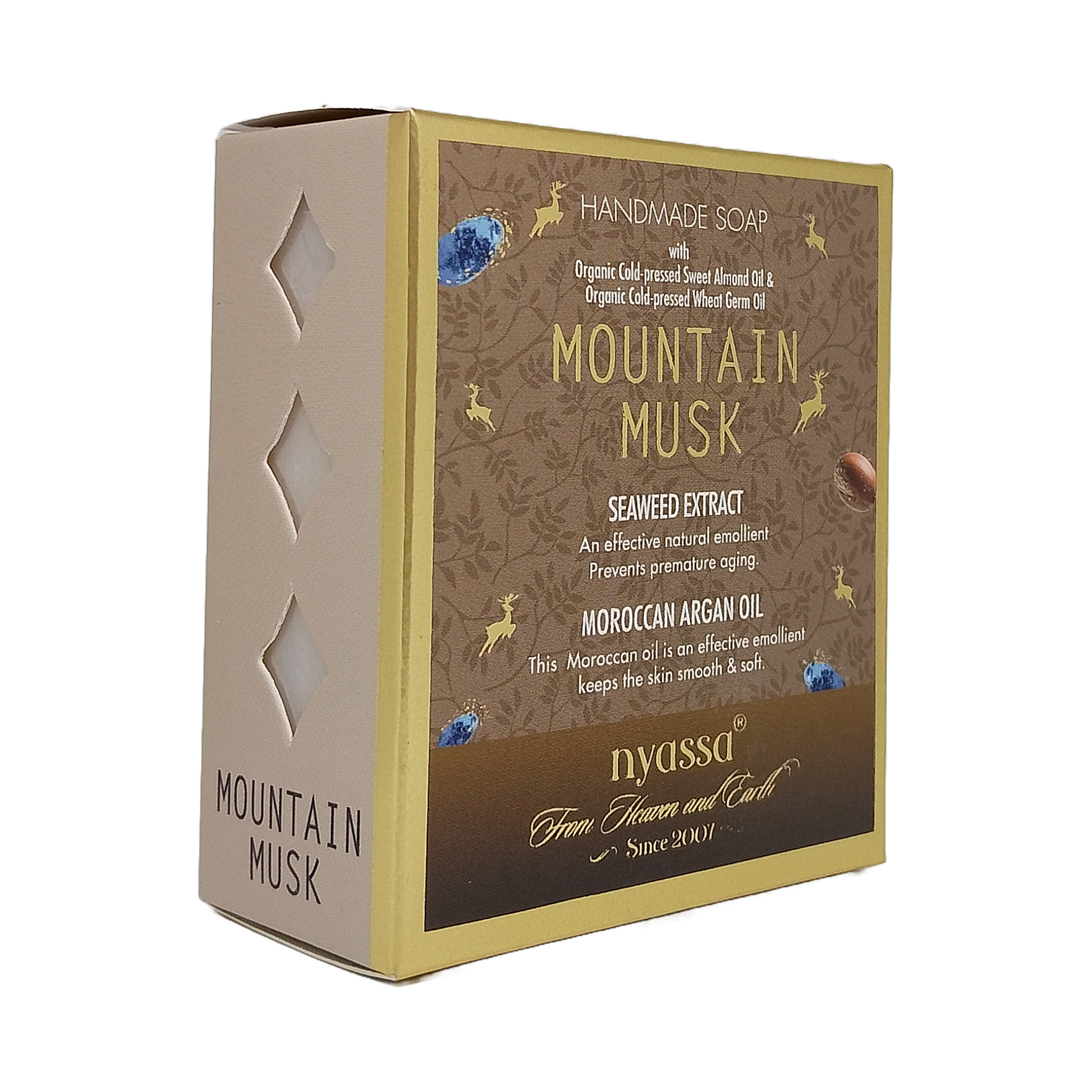 A boxed handmade soap product labeled 'Mountain Musk' by nyassa, shown on a plain white background. The package is a rectangular box with a beige side panel and a brown front label featuring gold text and decorative illustrations.