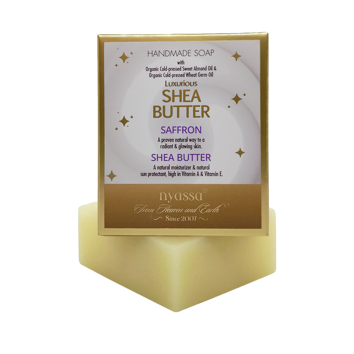 Nyasa Shea Butter Saffron handmade soap in a square gold and white box, displayed on a matching gold soap block against a white background.