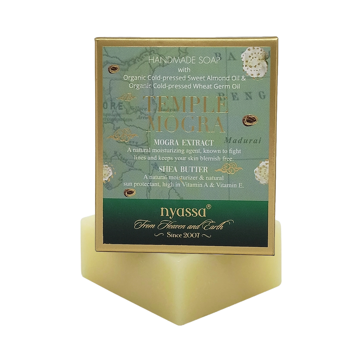 Nyassa Temple Mogra handmade soap in a gold-framed rectangular box with a green and teal label, displayed on a matching gold geometric stand against a white background.